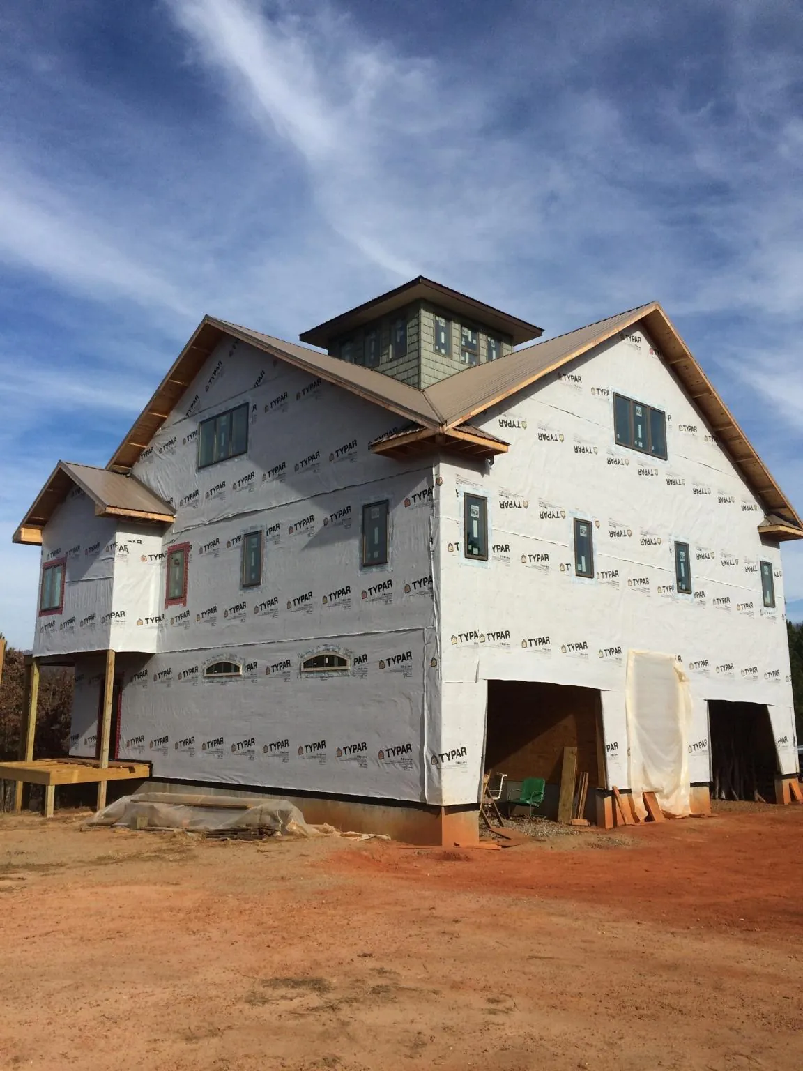 New two story house under construction with a cupola and gabled roofs in Edwards